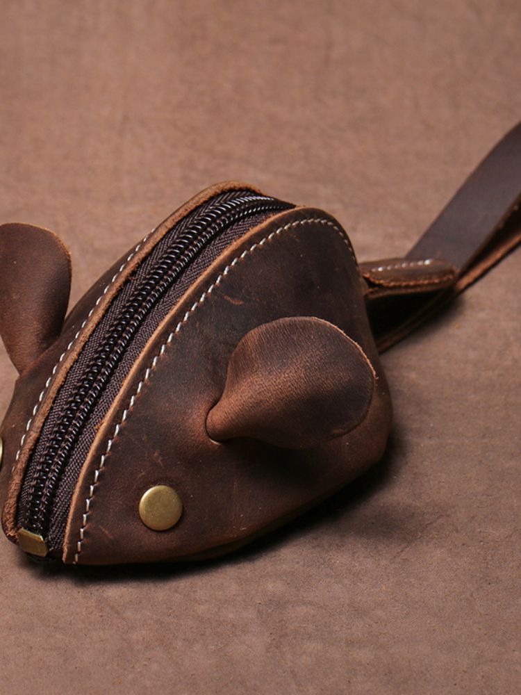 Bolsa pequena em formato de ratinho feita em couro marrom com zíper central e orelhas estruturadas
